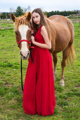 A beautiful young woman with a horse