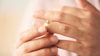 Woman takes off an wedding ring