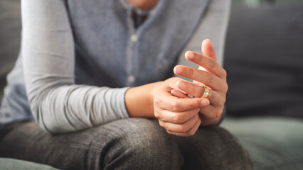 Woman takes off an wedding ring