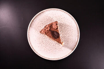 Plate with a piece of delicious homemade chocolate cake on the table. Chocolate cupcake. Dessert. Food