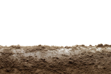 A close up view of wet brown soil with a black background showing the texture and moisture content