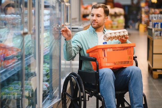 Customer in wheelchair buying groceries at the supermarket