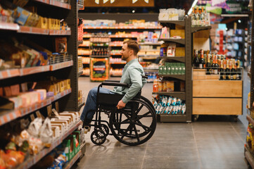 Customer using wheelchair choosing groceries in supermarket