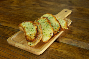 Garlic bread on wooden plate, Cooking concept.