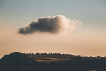 clouds over the hill and the woods in the alps