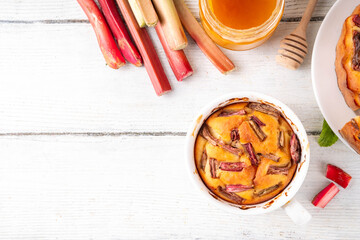 Summer homemade baking, quick microwave made cupcake, mugcake. Simple sweet seasonal dessert recipe, sponge cake with rhubarb slices on top and sweet jam inside