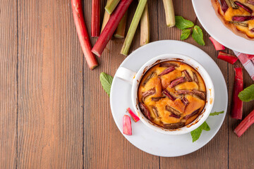 Summer homemade baking, quick microwave made cupcake, mugcake. Simple sweet seasonal dessert recipe, sponge cake with rhubarb slices on top and sweet jam inside