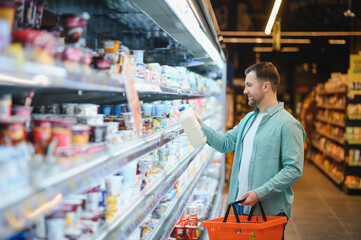 Man shopping for groceries in supermarket aisle