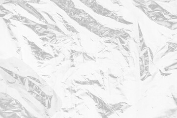 plastic overlay texture of crumpled transparent plastic film wrap on black background,wrinkled stretched plastic effect.