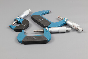 Three blue micrometers with various sizes, a micrometer is a tool to precisely measure the outer...