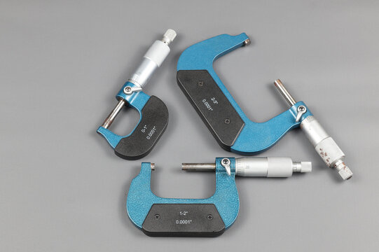 Three blue micrometers with various sizes, a micrometer is a tool to precisely measure the outer diameter and length (thickness) of an object to be measured by clamping it.