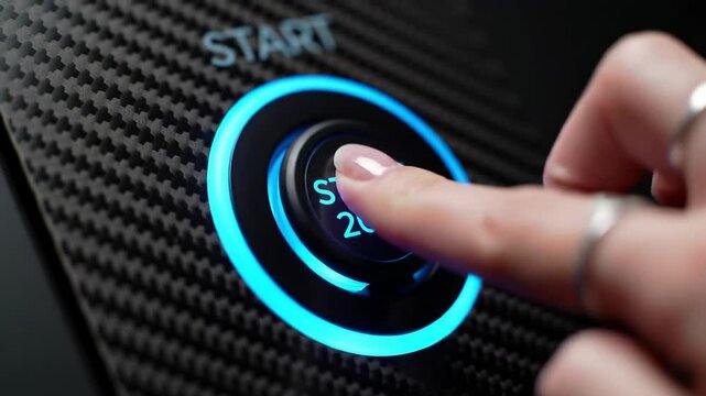 Female hand pressing illuminated start button on carbon fiber panel, futuristic interaction and action &ndash; Concept of beginning and innovation