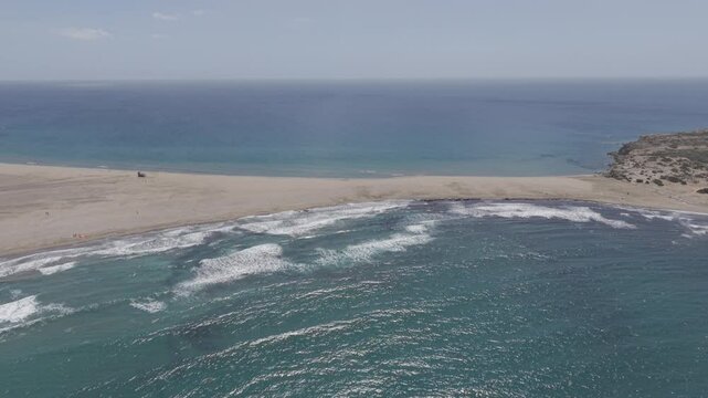 Drone clips during a sunny and windy day at the famous Prasonisi beach of Rhodes island in Greece, popular for kite surfers and wind surfers. Not graded. D-Log M
