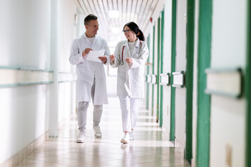 Fototapeta premium Doctors Walking in Hospital Hallway