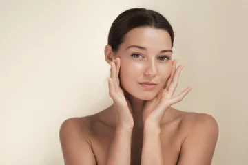 Fotobehang Beautiful Woman With Perfect Skin Touching Face In Skincare Concept  © Buyanskyy Production