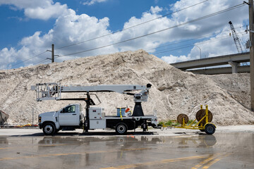 truck with lift bucket and cable trailer at highway construction site  © Francisco