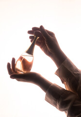 Hand Holding Bottle of Perfume. Modern Luxury Parfum De Toilette. Perfume Spray. 