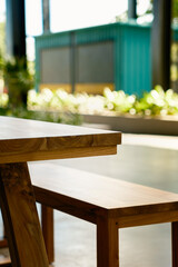 Natural material beauty. Close-up abstract of durable wooden outdoor furniture, showing the quality craftsmanship and rich color. The sunny environment creates a pleasant, inviting atmosphere.