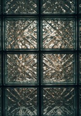 Textured Glass Block Wall Reflection - Geometric glass blocks, light refraction, textured surface, modern design, architectural detail. Symbolizing structure, clarity, light, modern aesthetics