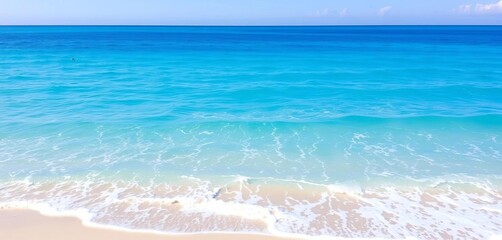 Serene turquoise water, gentle waves lapping a sandy shore under a clear sky, paradise, summer
