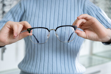 Close up picture of hands with eyeglasses