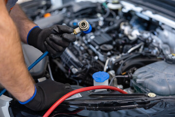 Mechanic with toolbox and laptop in workshop