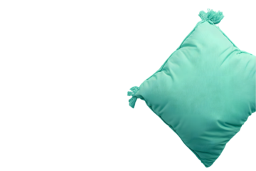 A light teal, square cushion with tassels sits against a black background.  Soft, plush texture implied