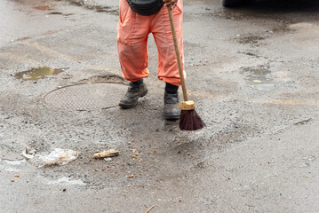 Cleaning worker cleaning the floor of a street. Concept of public hygiene and care.