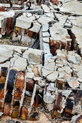 Winter strong fierce storm (cyclone) destroyed a stone house on a sandy beach. The wall fell under...
