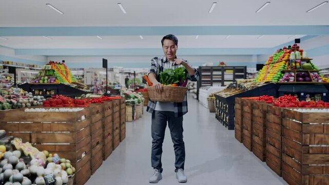 Full Body Of Asian Male Farmer With Vegetable Basket Doing Ooh Face in Grocery Store
