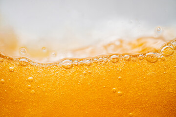 Close up bright orange Oil or beer splash texture and nature waves, Beautiful waves curve and little bubbles smooth for graphic design and background, Oil Bubbles, Soft beer bubbles, Selective focus