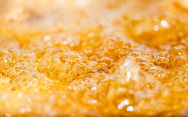 Close up bright orange Oil or beer splash texture and nature waves, Beautiful waves curve and...