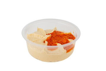Hummus with a spicy paprika sauce is in a transparent plastic container. The arrangement appears fresh and appetizing.
