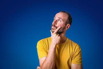 portrait of young man confused an uncertain, shrugging with open hands. Bewildered and clueless person