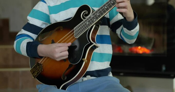 Caucasian Kid Play Mandolin at Home. European Boy Practice Music 4K 10-bit