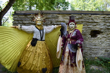 Obraz premium Two Ornate Carnival Costumes with Wings and Fan