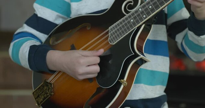 Caucasian Kid Play Mandolin at Home. European Boy Practice Music 4K 10-bit