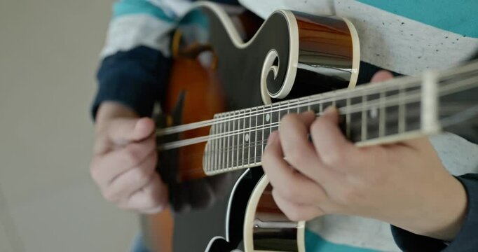 Caucasian Kid Play Mandolin at Home. European Boy Practice Music 4K 10-bit