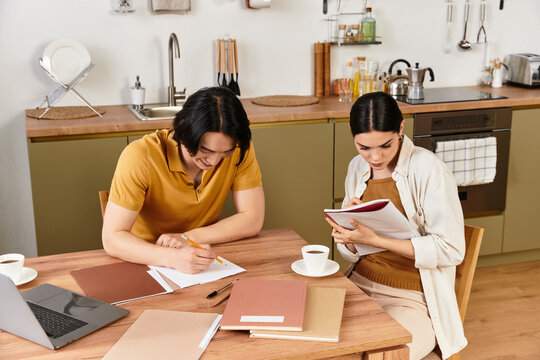 Intimate moments of a couple sharing creative ideas at home over warm drinks