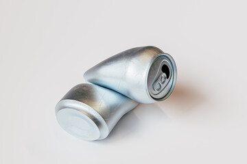 Can of soda is laying on a white surface. The can is crumpled and folded in half. 3d render