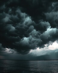 Obraz premium Ominous storm clouds gathering over the dark sea creating a dramatic and moody atmosphere nature photography