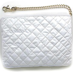 Luxurious white quilted pouch with a gold chain strap close up shot