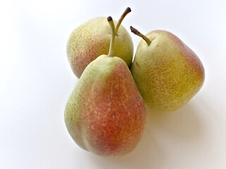 Three green pears with a red spot on the top