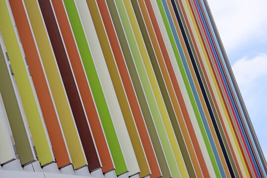 Exterior of a cark park with permeable colourful slat wall to allow for ventilation and light to flow through the wall