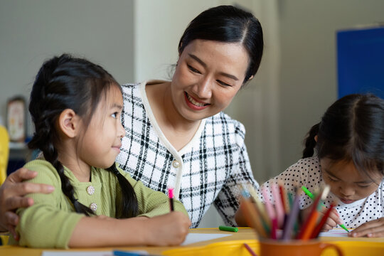 Back to School. Teacher engaging with students during a creative classroom activity.