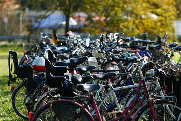 Many bicycles parked in row outdoors representing sustainable transportation