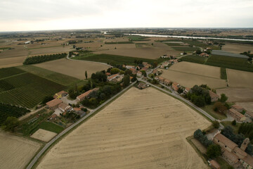 Cultivated fields and rural houses creating a picturesque landscape in northern italy