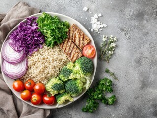 Overhead shot of healthy vegan bowl with quinoa grilled tofu and fresh vegetables on gray background studio shot