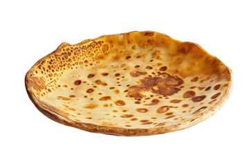 Irregularly-shaped, shallow dish with a rustic, golden-brown surface, featuring a textured, slightly bubbly appearance and uneven edges