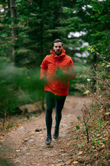 Jogger in Autumn Forest Trail